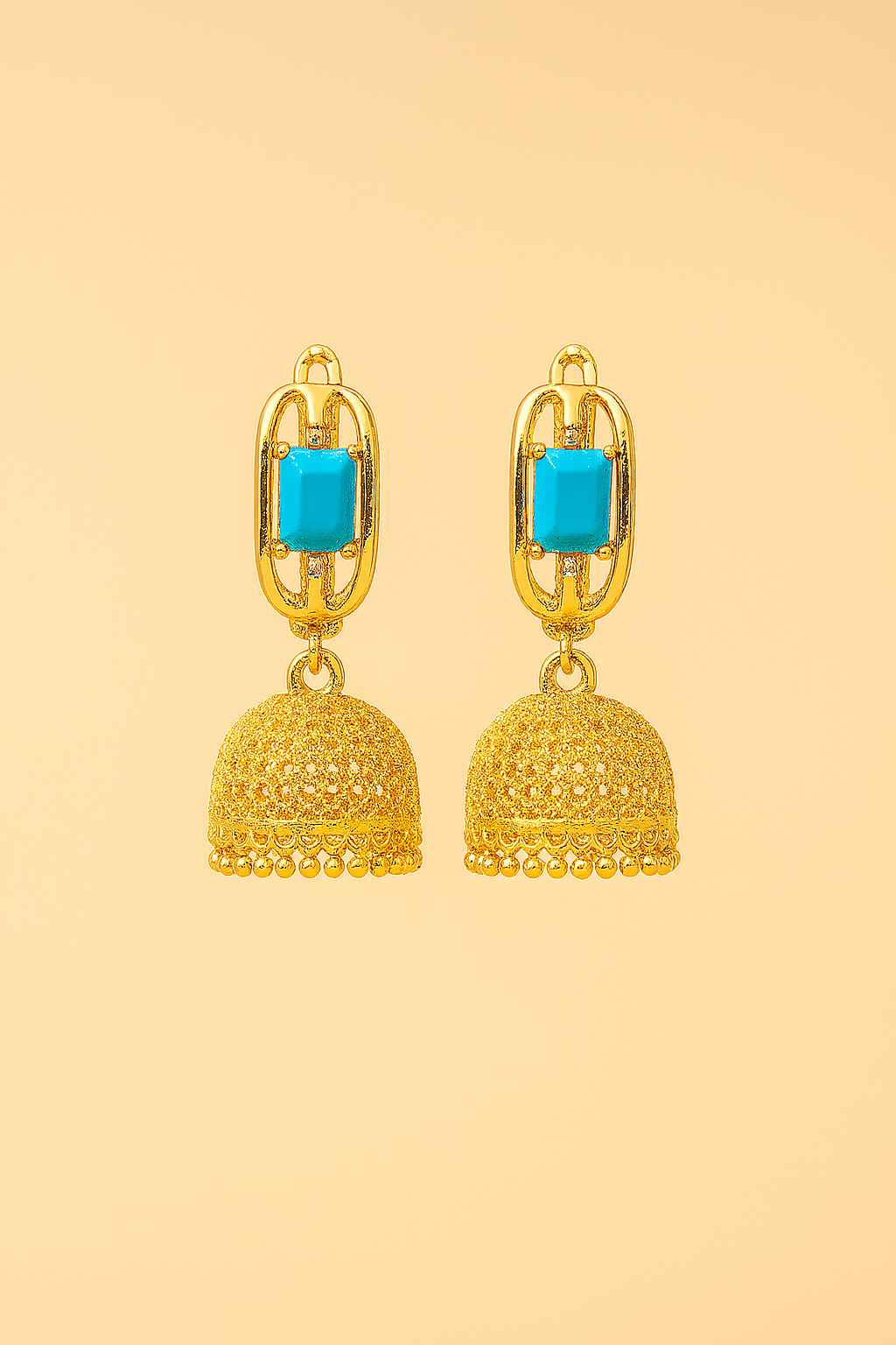 Gold earrings with turquoise stones on a beige background