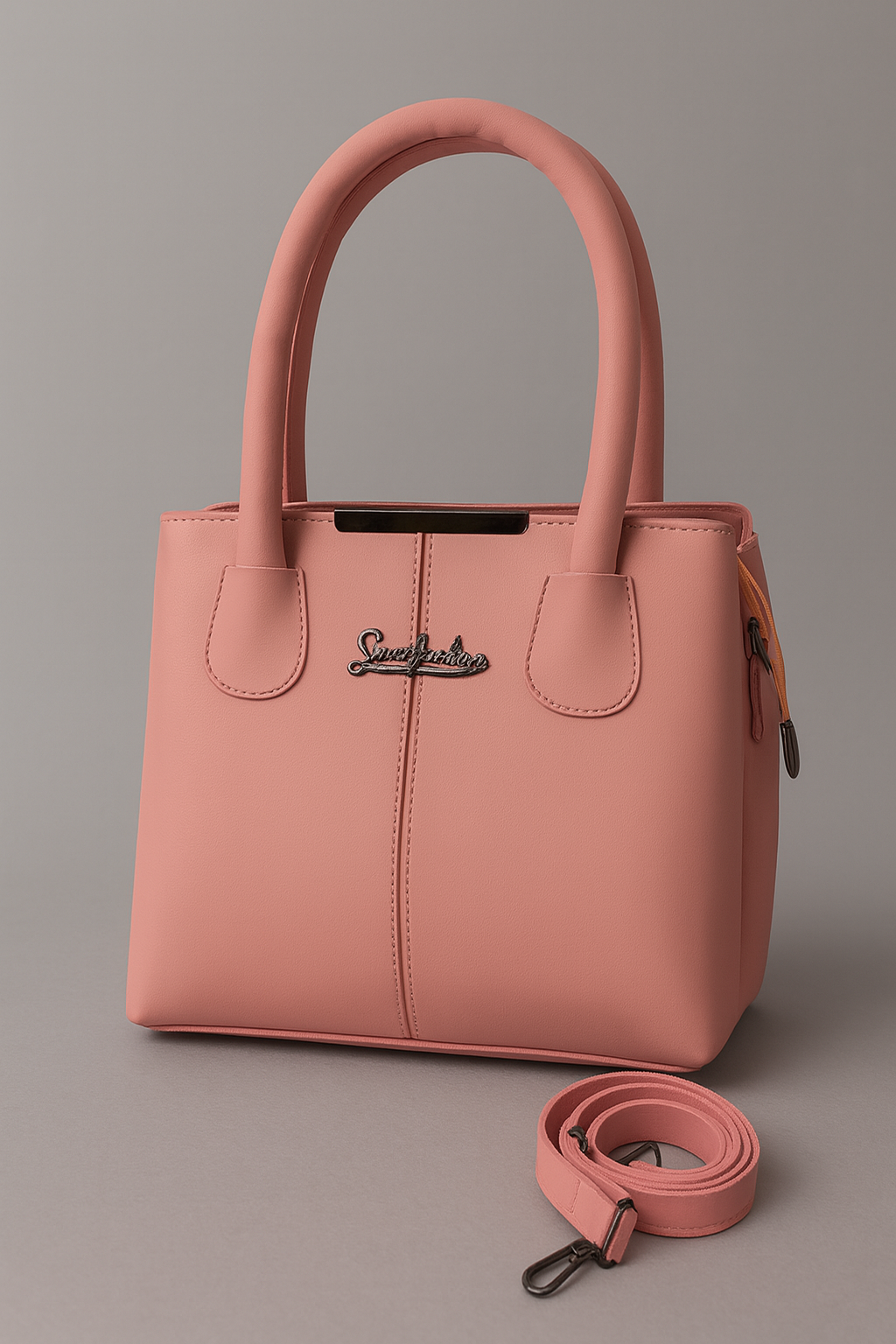 Pink handbag with a strap on a gray background