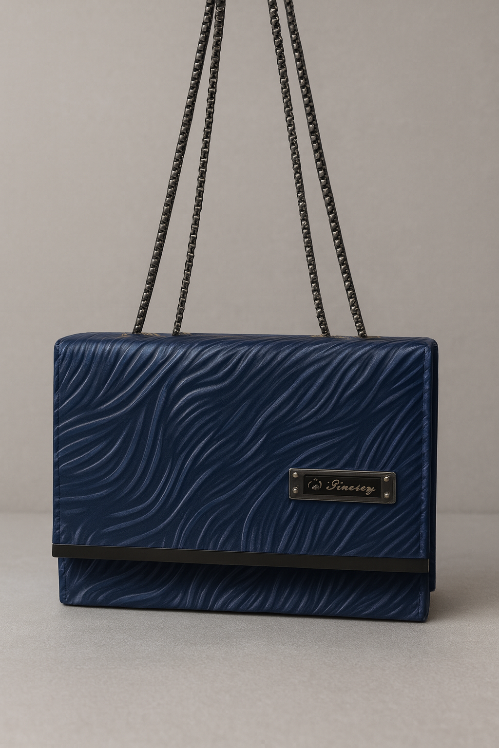 Blue handbag with a chain strap on a gray background