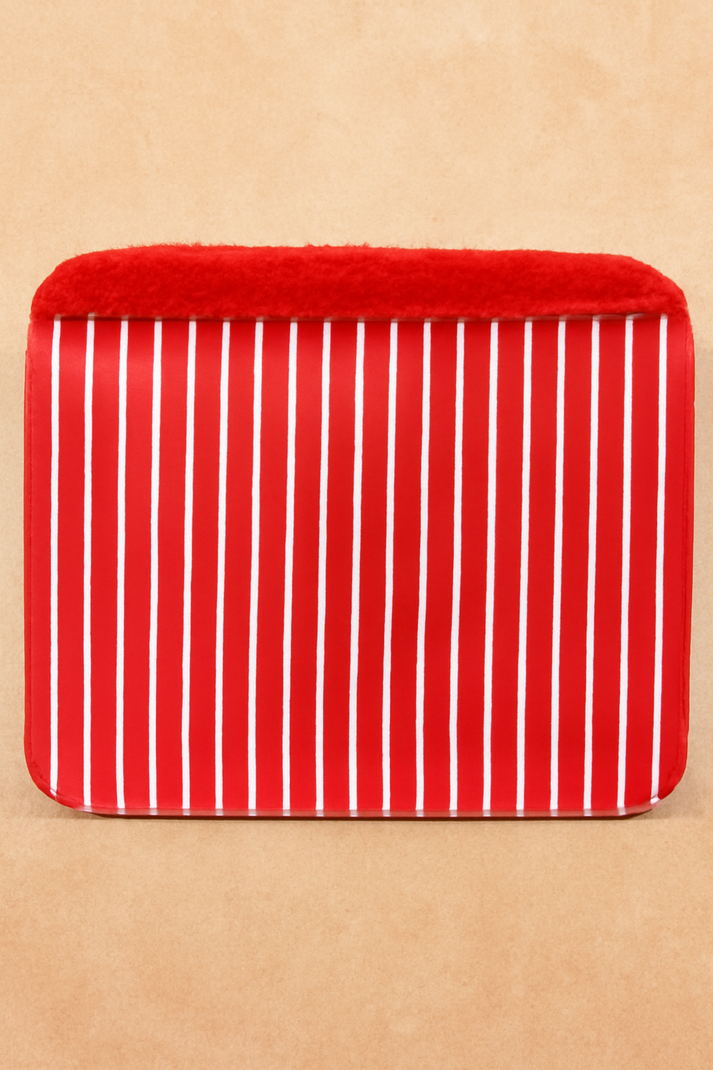 Red and white striped pouch on a beige background