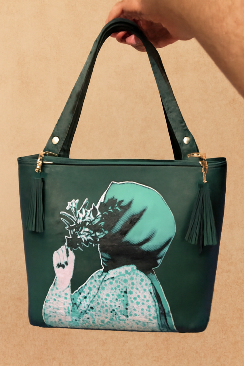 Green handbag with artistic design on a beige background