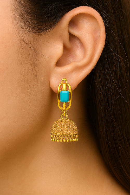 A pair of artificial gold-tone jhumka earrings with a turquoise-colored faux stone and dome-shaped danglers