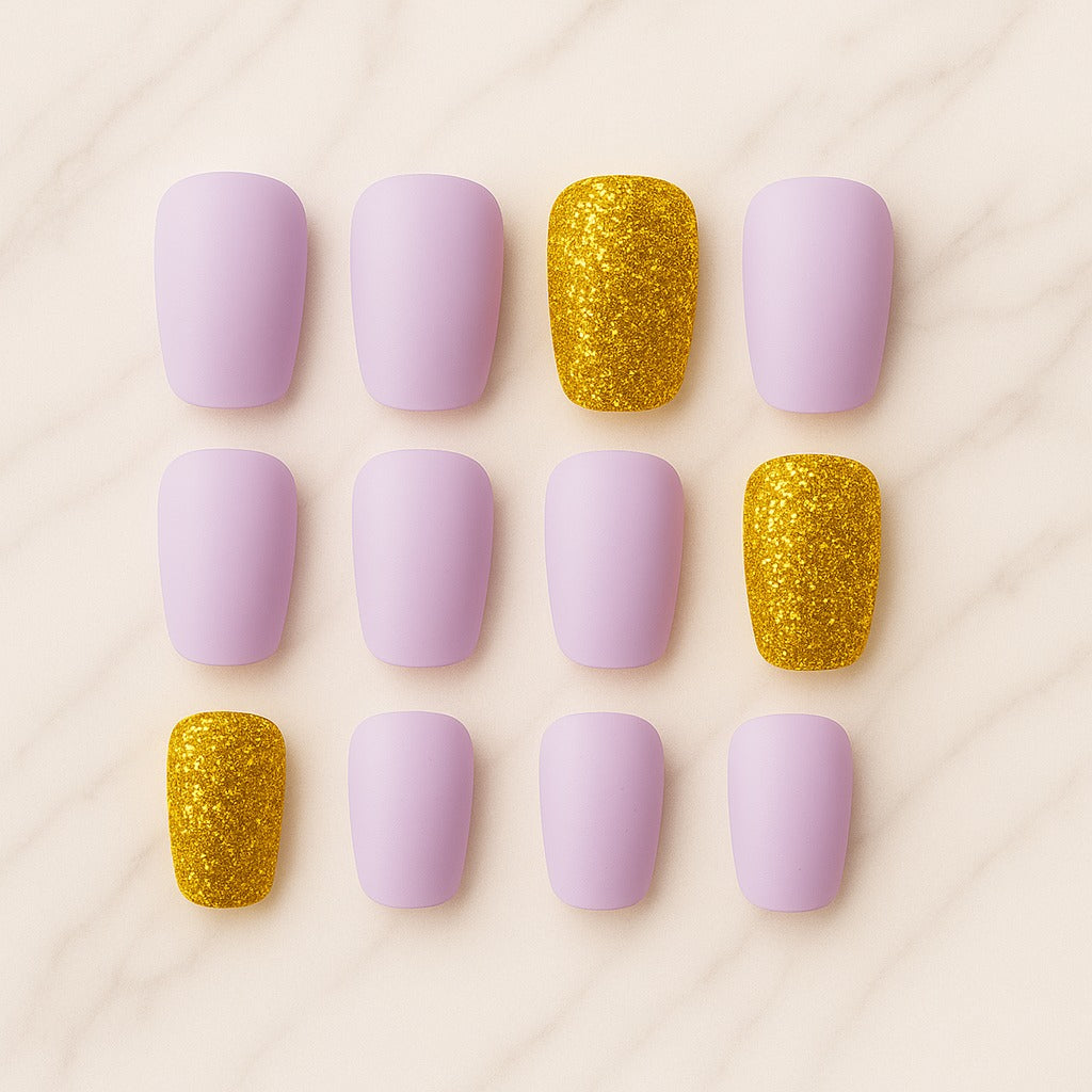 Nail art display with purple and gold nails on a light pink background