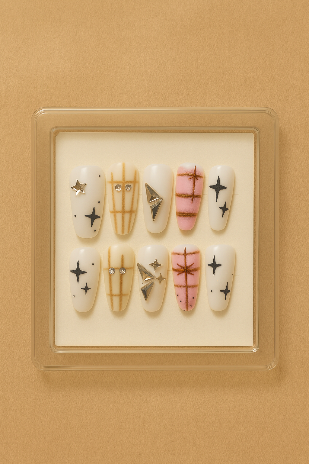 Set of nail art designs in a clear display case on a beige background