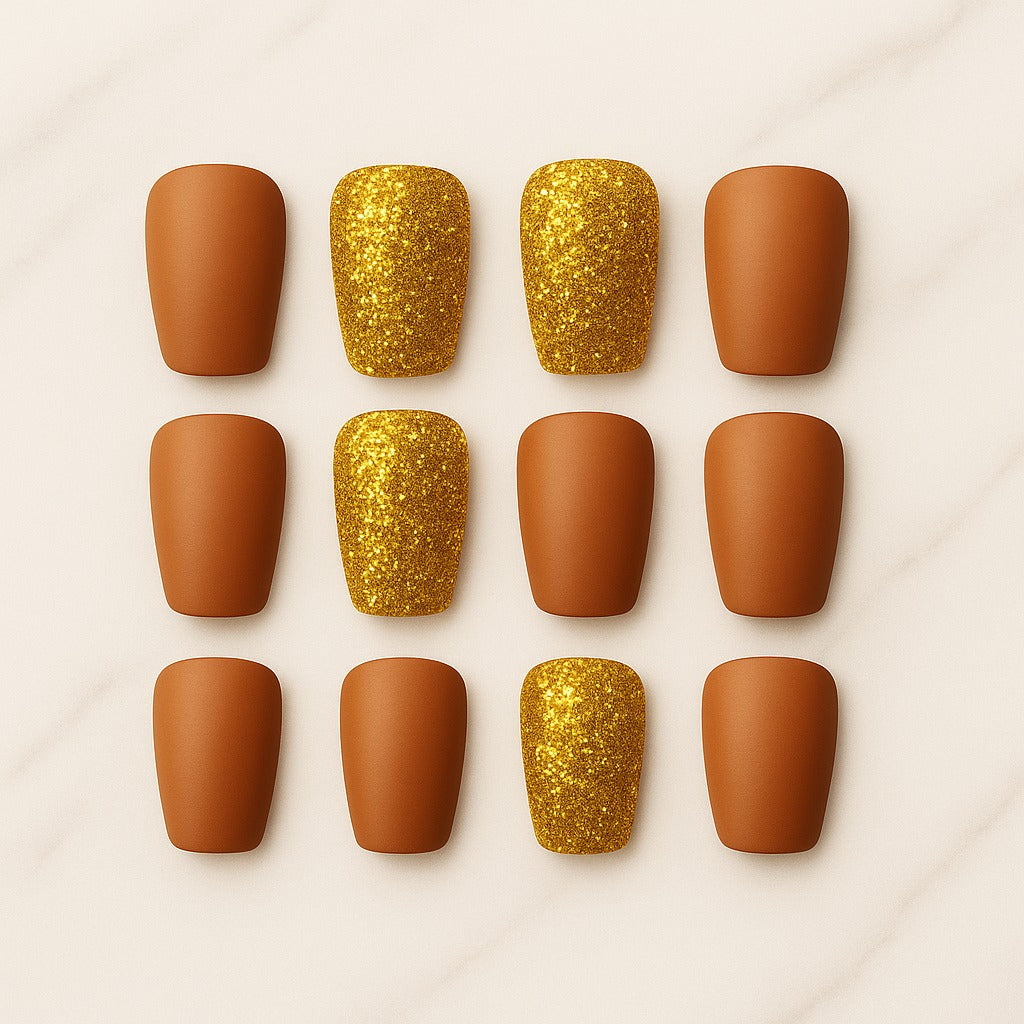Nail art tips with gold glitter and brown matte finishes arranged in a 3x3 grid on a light background.